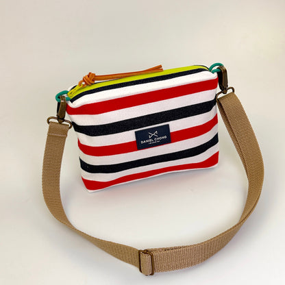 BANDOLERA MINI LONA RÚSTICA RAYAS ROJAS Y AZULES, ZIP VERDE FLÚOR